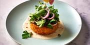 Fishcake topped with coriander and red onion