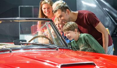 Family looking at car in Haynes Motor Museum