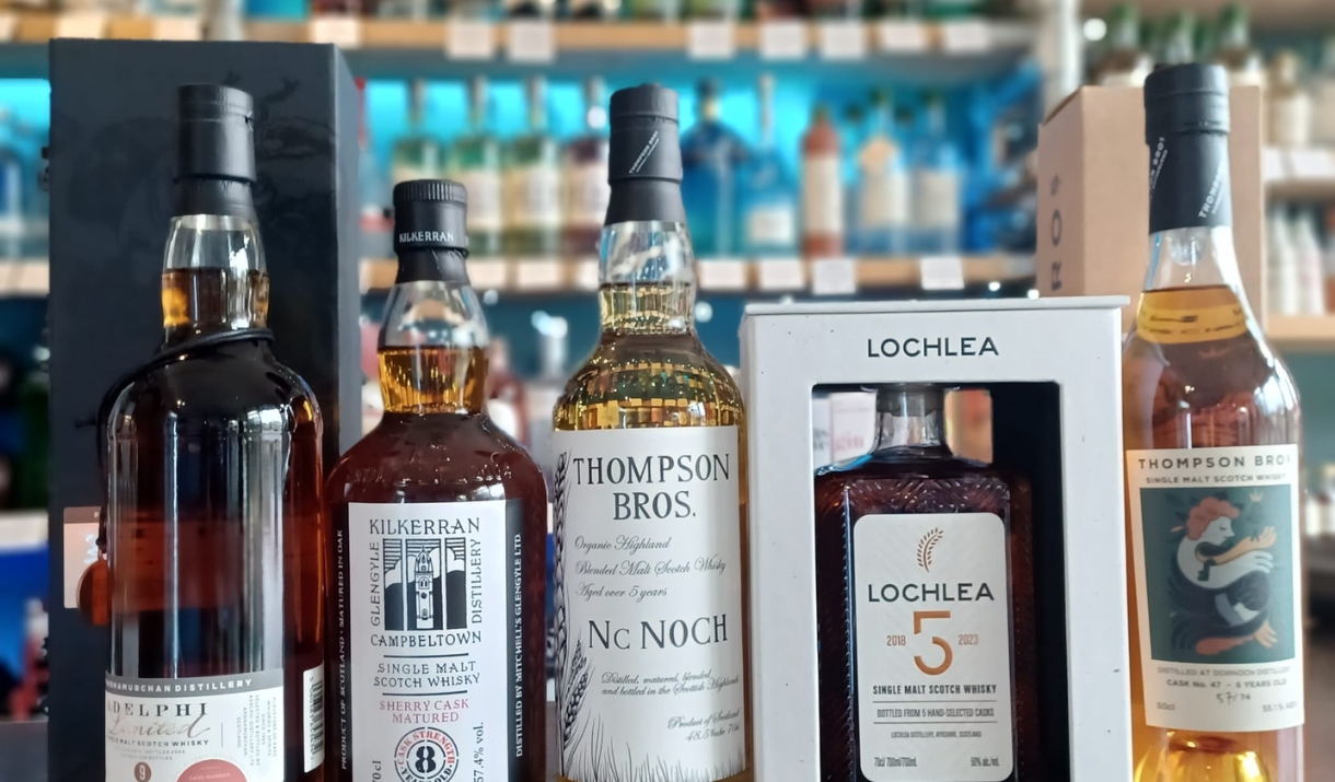 A selection of 5 rare whiskies sitting on a counter at Independent Spirit of Bath