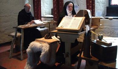 A nun and monk transcribing medieval books