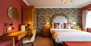 The Bear Inn bedroom with patterned wallpaper
