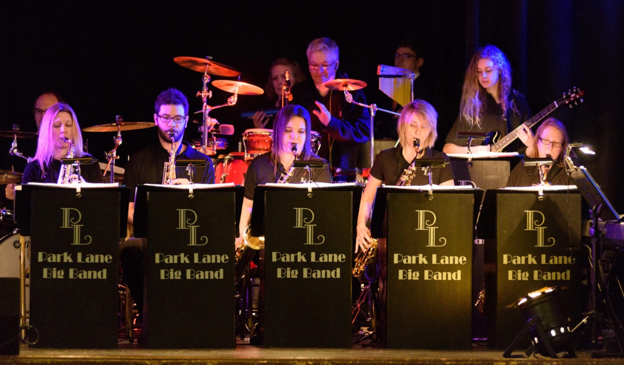A brass band performing on stage