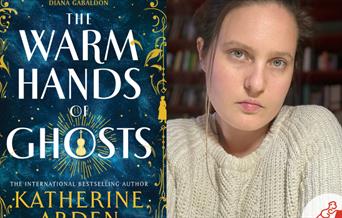 Author Katherine Arden with her book The Warm Hands of Ghosts