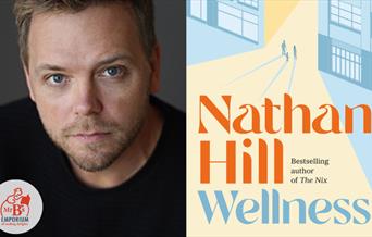 Author Nathan Hill with his book Wellness