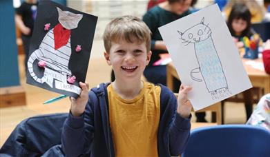 A child holding a cat artwork