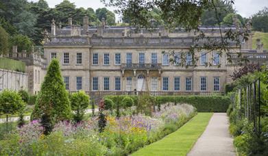 View of the West Front and garden in summer at Dyrham Park.