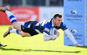 Ben Spencer dives over the try line to score points for Bath Rugby.