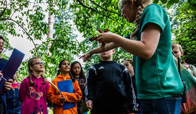 Children participating in Arboretum Apprentice activity with guide