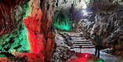 Wookey Hole caves illuminated in red and green
