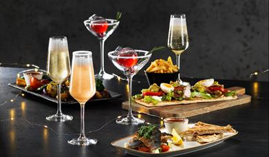 Image shows a selection of Bar + Block's festive lunch food and drinks.